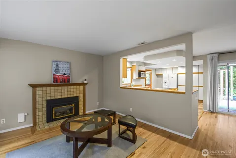 a living room with furniture a rug and a fireplace