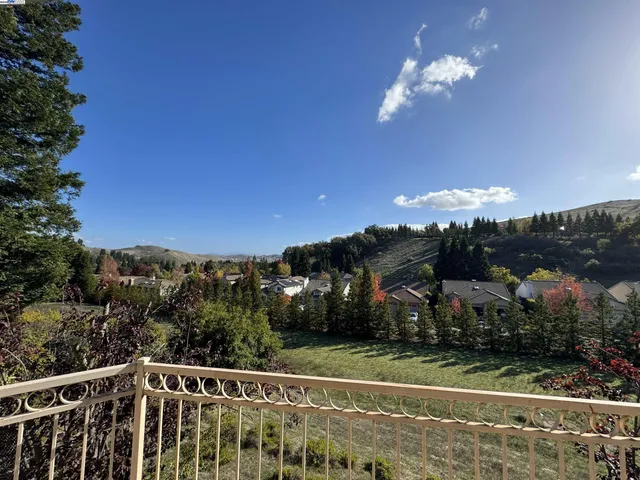 a view of a balcony with a yard