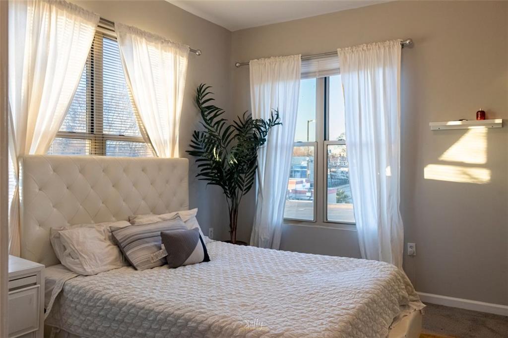 870 Mayson Turner Road Northwest, Unit 1214 Atlanta, GA 30314 - Photo 1 of 1 a bedroom with a large bed and a window