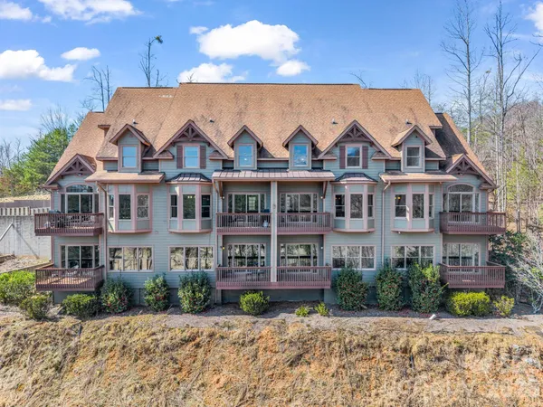 a front view of a residential apartment building with a yard