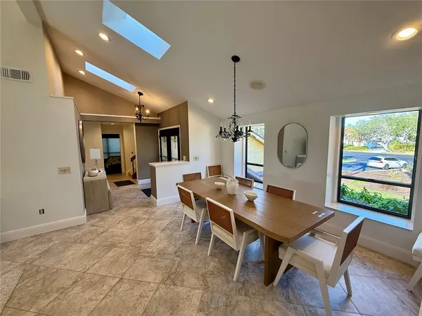 a view of a dining room and a table chairs