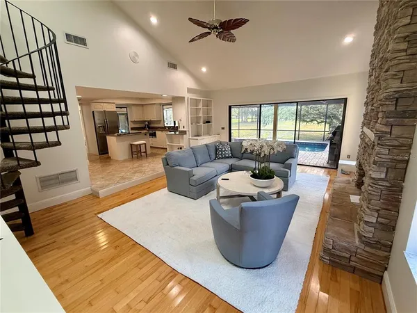 a living room with a couch fireplace and a wooden floor