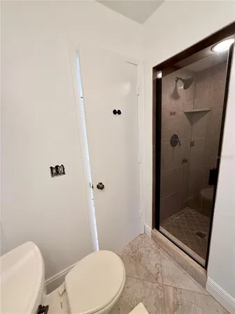 a view of a balcony with chair and wooden floor