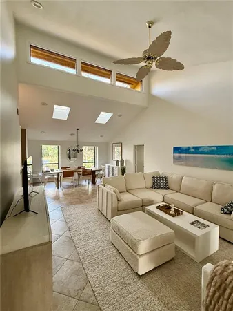 a living room with furniture and a ceiling fan