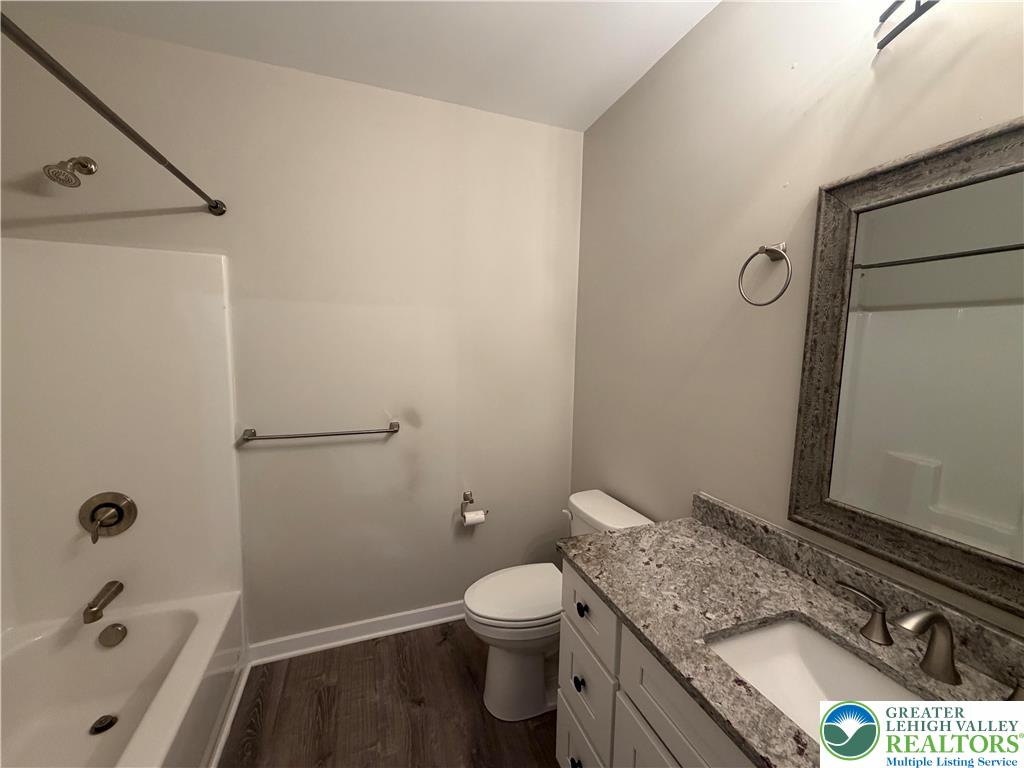 7120 Suter Road Coopersburg, PA 18036 - Photo 11 of 17 a bathroom with a granite countertop sink a toilet and shower