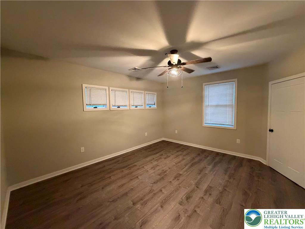 7120 Suter Road Coopersburg, PA 18036 - Photo 12 of 17 a view of an empty room with a window and wooden floor