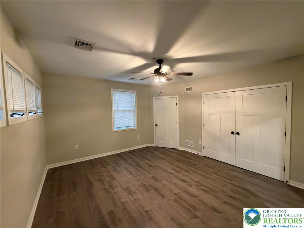 7120 Suter Road Coopersburg, PA 18036 - Photo 13 of 17 an empty room with wooden floor fan and windows