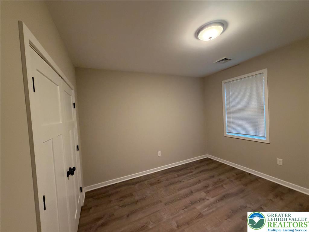 7120 Suter Road Coopersburg, PA 18036 - Photo 17 of 17 an empty room with wooden floor and windows