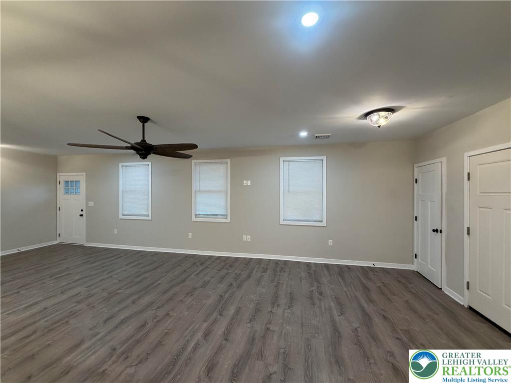 7120 Suter Road Coopersburg, PA 18036 - Photo 9 of 17 a view of an empty room with wooden floor and a ceiling fan