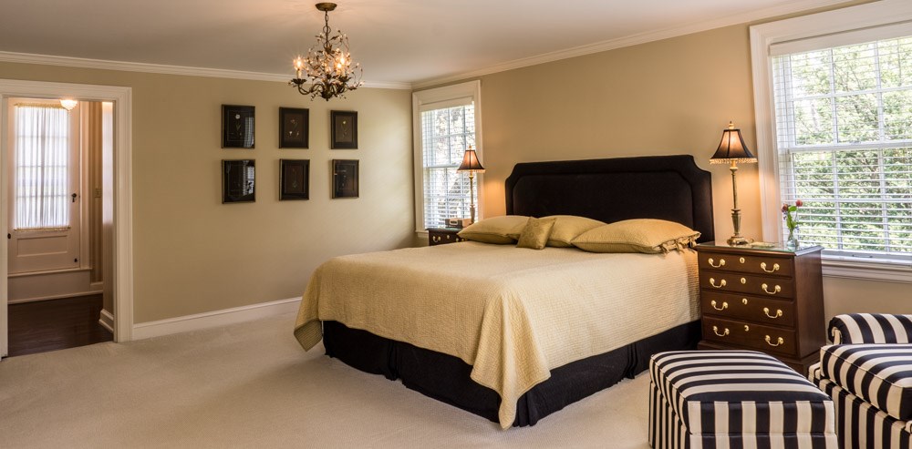 3624 Brookview Road Rockford, IL 61107 - Photo 13 of 25 a bedroom with a bed and a chandelier