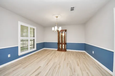 a spacious bedroom with a bed and a large window