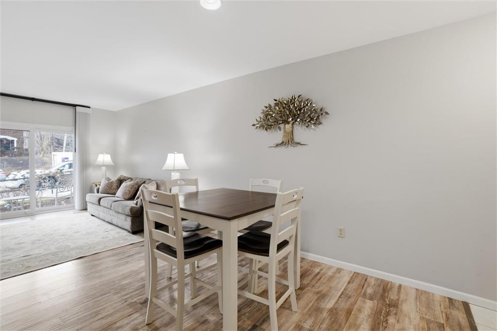 5715 Beacon Street, Unit 107 Pittsburgh, PA 15217 - Photo 11 of 50 a view of a dining room with furniture and wooden floor