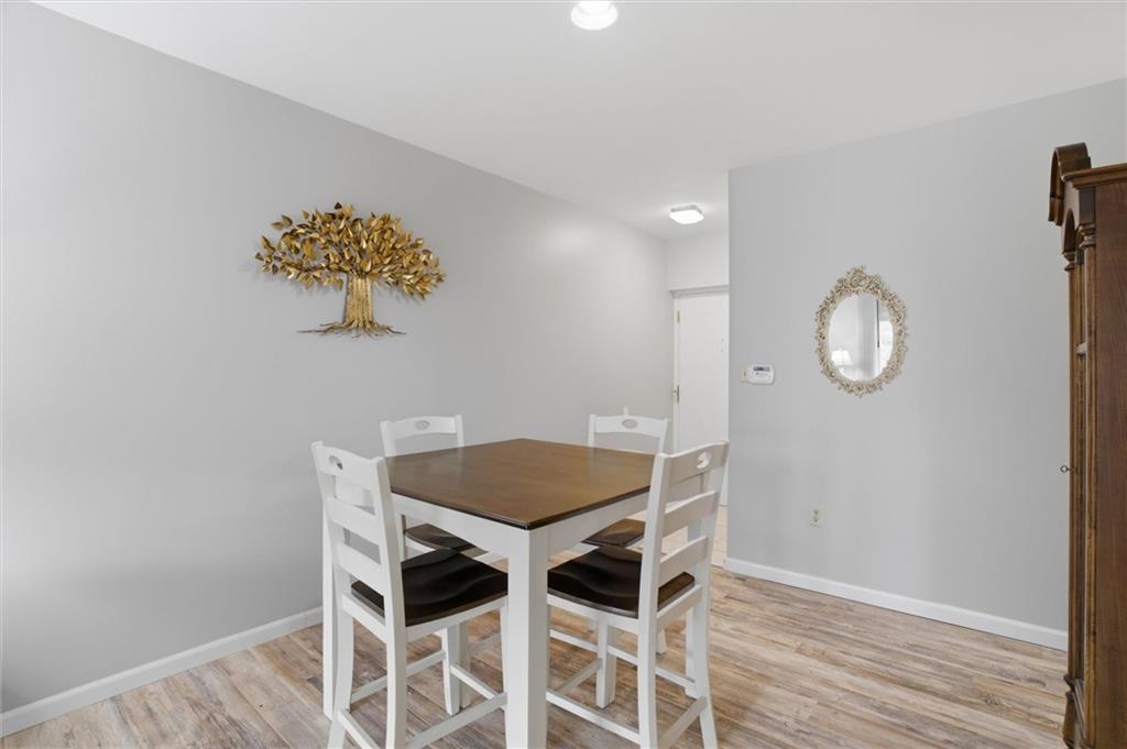 5715 Beacon Street, Unit 107 Pittsburgh, PA 15217 - Photo 12 of 50 a view of a dining room with furniture and wooden floor