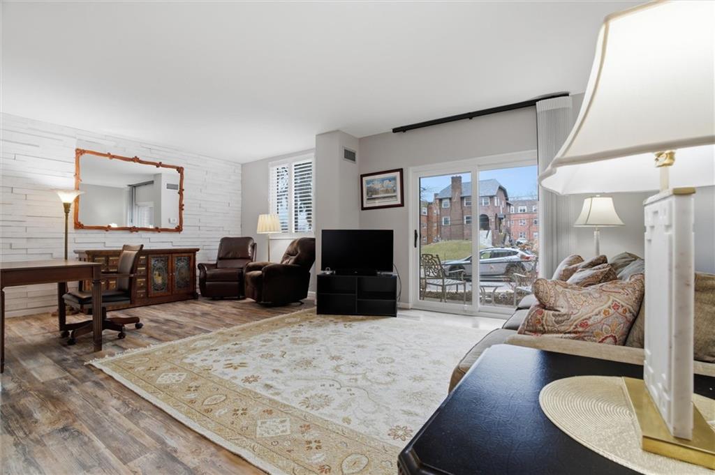 5715 Beacon Street, Unit 107 Pittsburgh, PA 15217 - Photo 13 of 50 a living room with furniture and a large window