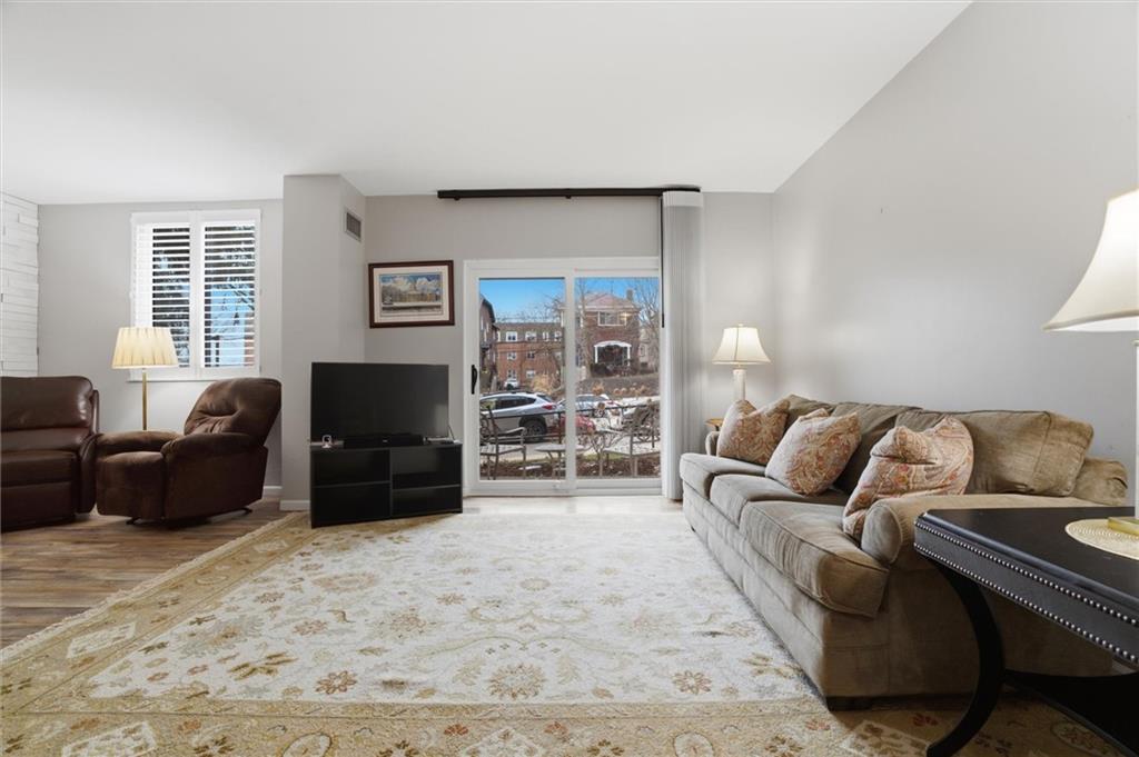 5715 Beacon Street, Unit 107 Pittsburgh, PA 15217 - Photo 14 of 50 a living room with furniture and a flat screen tv