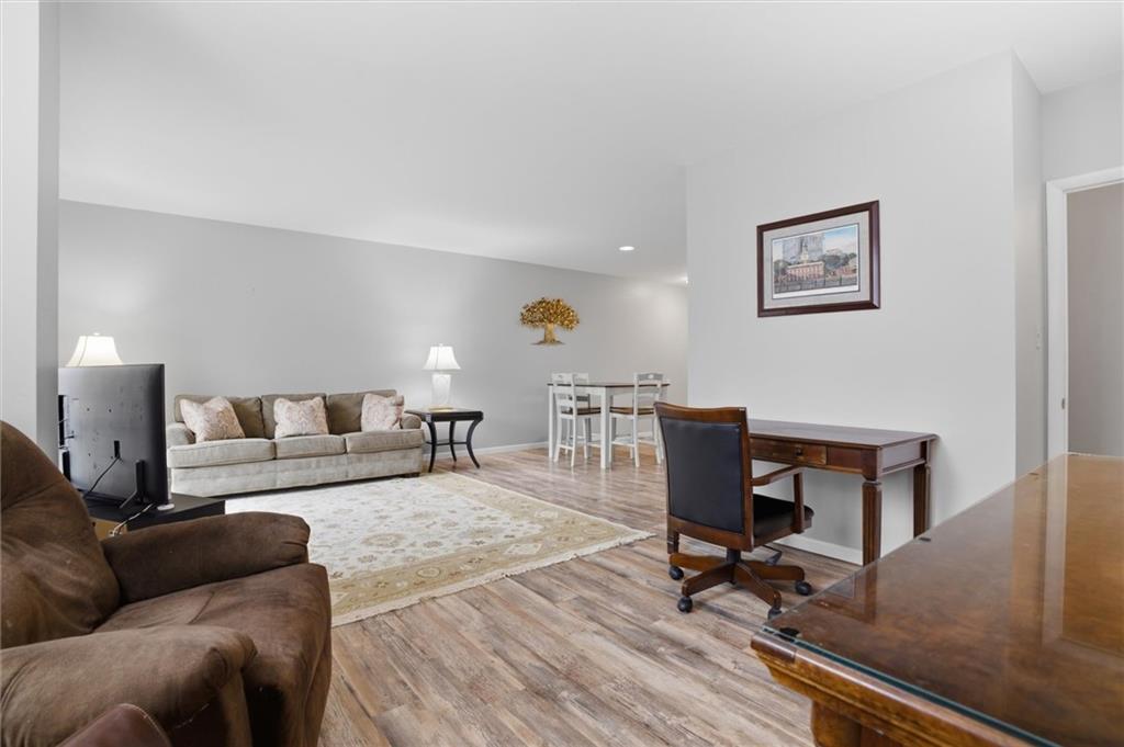 5715 Beacon Street, Unit 107 Pittsburgh, PA 15217 - Photo 18 of 50 a living room with furniture and a wooden floor