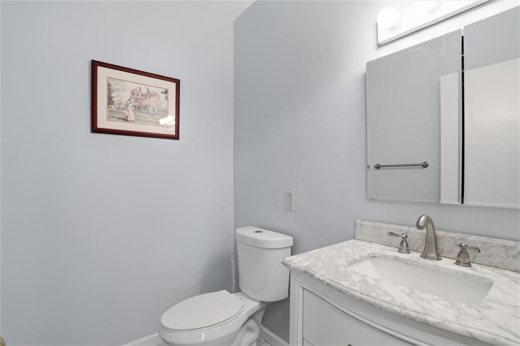 5715 Beacon Street, Unit 107 Pittsburgh, PA 15217 - Photo 25 of 50 a bathroom with a granite countertop toilet sink and mirror