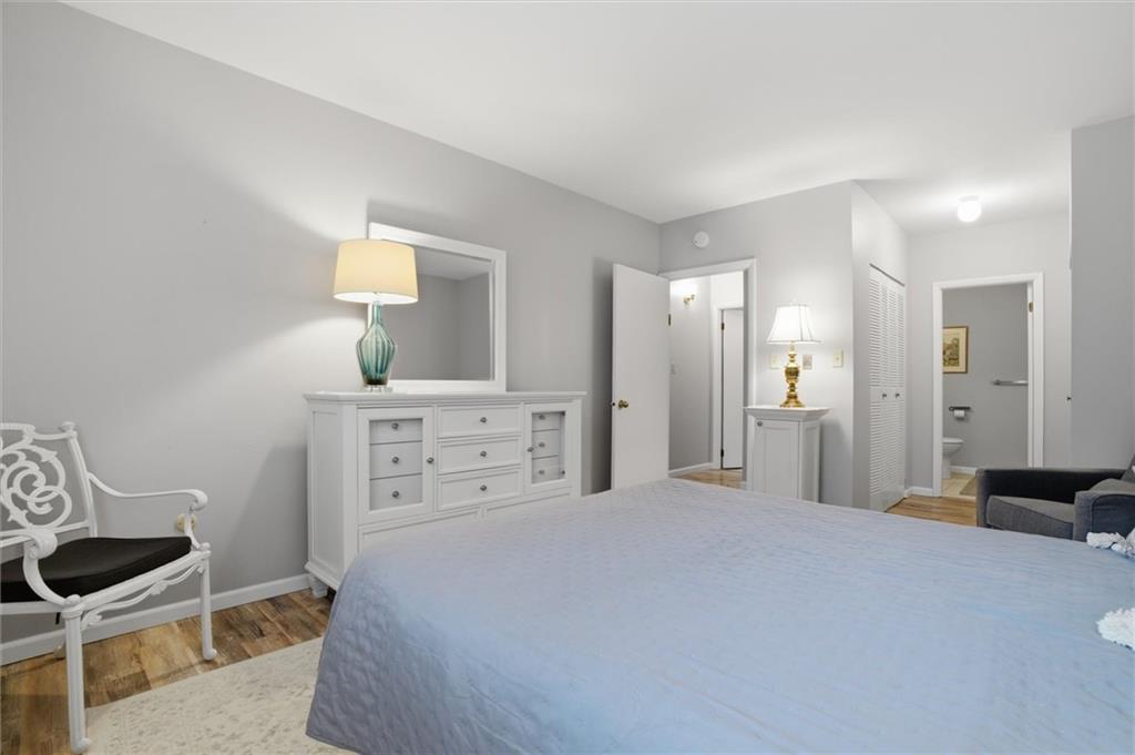 5715 Beacon Street, Unit 107 Pittsburgh, PA 15217 - Photo 30 of 50 a bedroom with a bed and a lamp