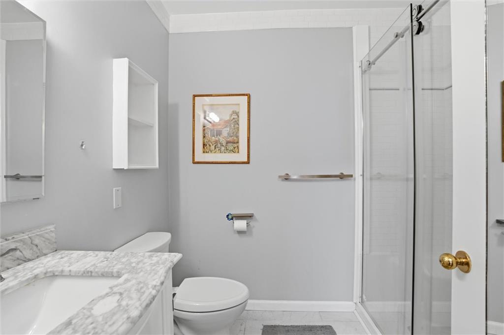 5715 Beacon Street, Unit 107 Pittsburgh, PA 15217 - Photo 34 of 50 a bathroom with a toilet a sink and shower