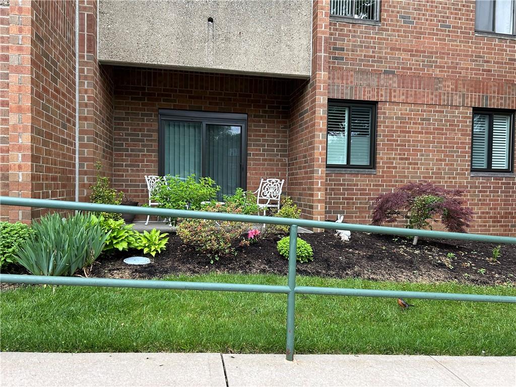 5715 Beacon Street, Unit 107 Pittsburgh, PA 15217 - Photo 47 of 50 a front view of a house with a garden