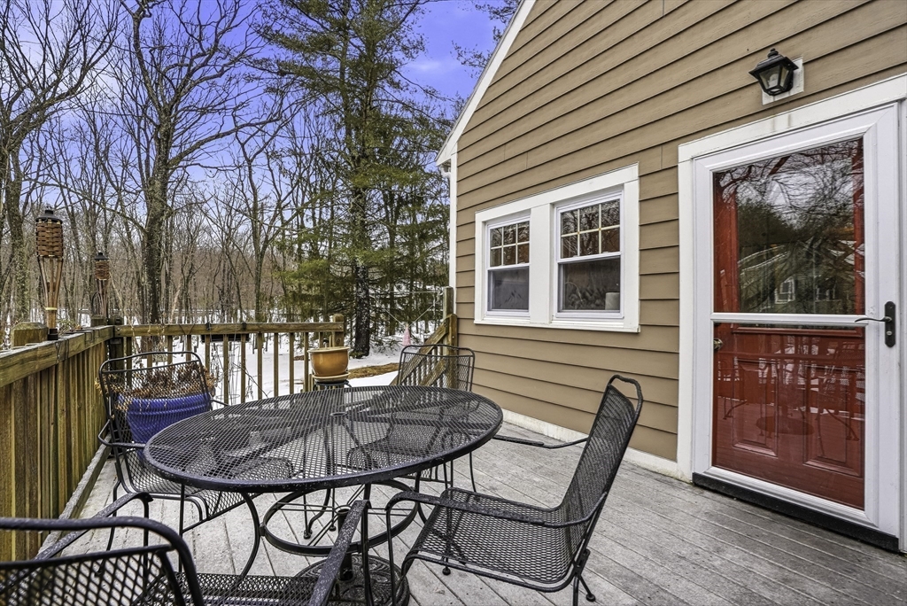 300 West Main Street Hopkinton, MA 01748 - Photo 18 of 26 a view of a patio with table and chairs with wooden floor and fence
