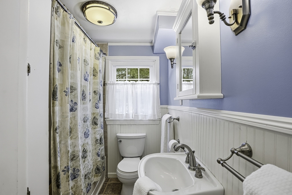 300 West Main Street Hopkinton, MA 01748 - Photo 23 of 28 a bathroom with a sink mirror vanity and toilet