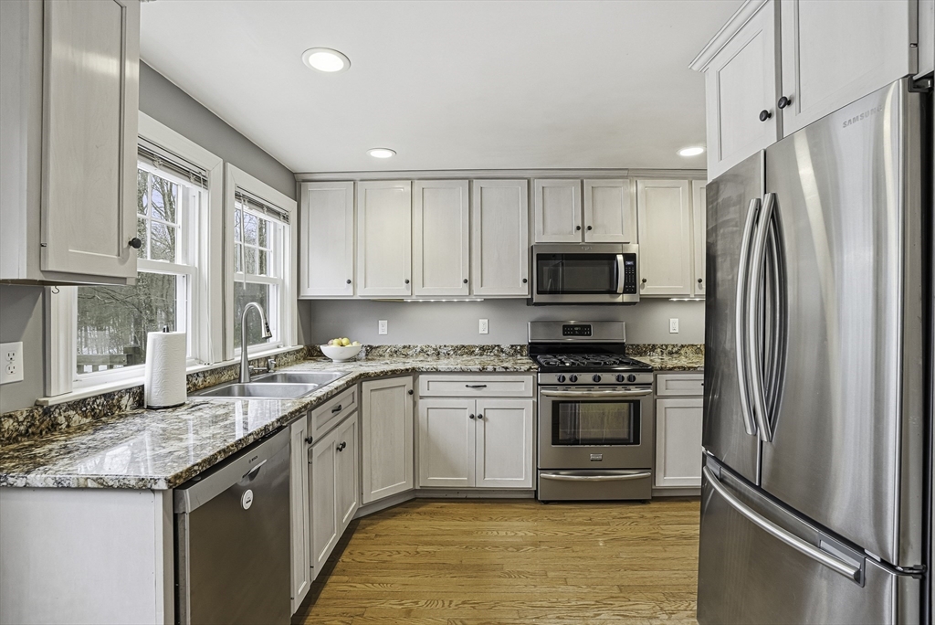 300 West Main Street Hopkinton, MA 01748 - Photo 9 of 28 a kitchen with stainless steel appliances granite countertop a stove a refrigerator and a sink