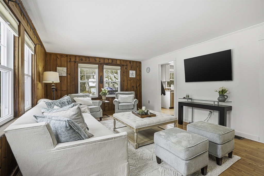300 West Main Street Hopkinton, MA 01748 - Photo 10 of 26 a living room with furniture a flat screen tv and a large window