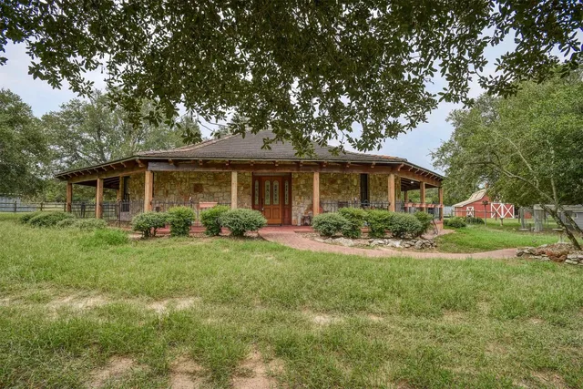 a front view of house with yard and green space