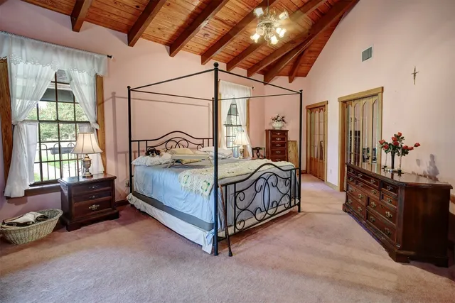 a bedroom with a bed and a dresser