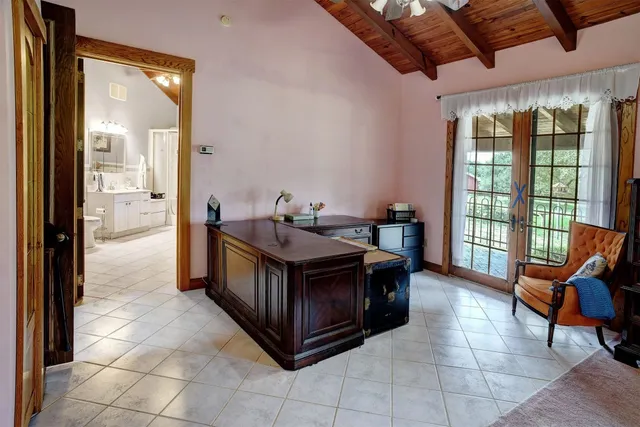 a dining room with a large window and a view of bedroom
