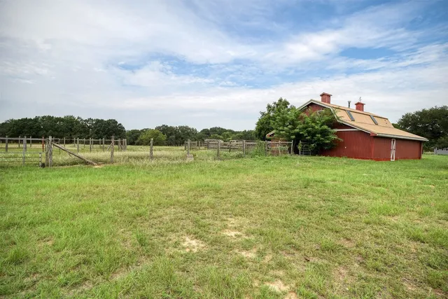 a view of a lake with houses in back
