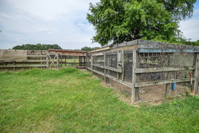 an aerial view of a house with a yard table and chairs