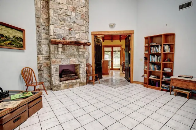 a living room with furniture a rug and a fireplace