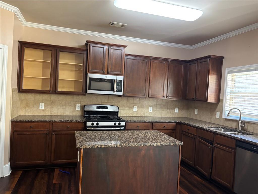 7562 Watson Circle Locust Grove, GA 30248 - Photo 11 of 66 a kitchen with sink a microwave and cabinets