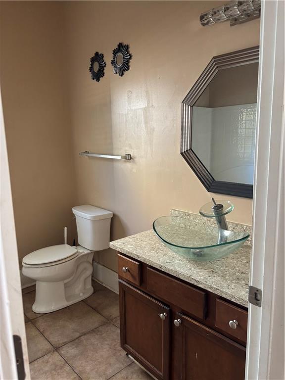 7562 Watson Circle Locust Grove, GA 30248 - Photo 18 of 66 a bathroom with a granite countertop toilet sink and mirror