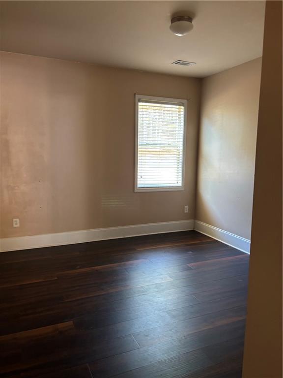 7562 Watson Circle Locust Grove, GA 30248 - Photo 19 of 66 an empty room with wooden floor and windows