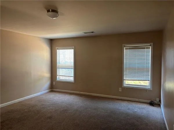 an empty room with a space and a window