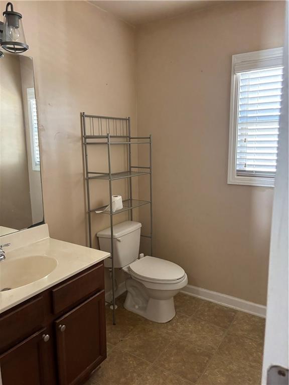 7562 Watson Circle Locust Grove, GA 30248 - Photo 32 of 66 a bathroom with a sink a toilet a mirror and shower