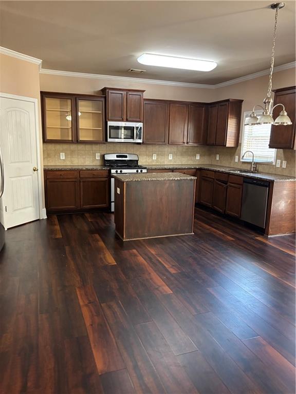 7562 Watson Circle Locust Grove, GA 30248 - Photo 42 of 66 a kitchen with stainless steel appliances kitchen island granite countertop a sink cabinets and wooden floor