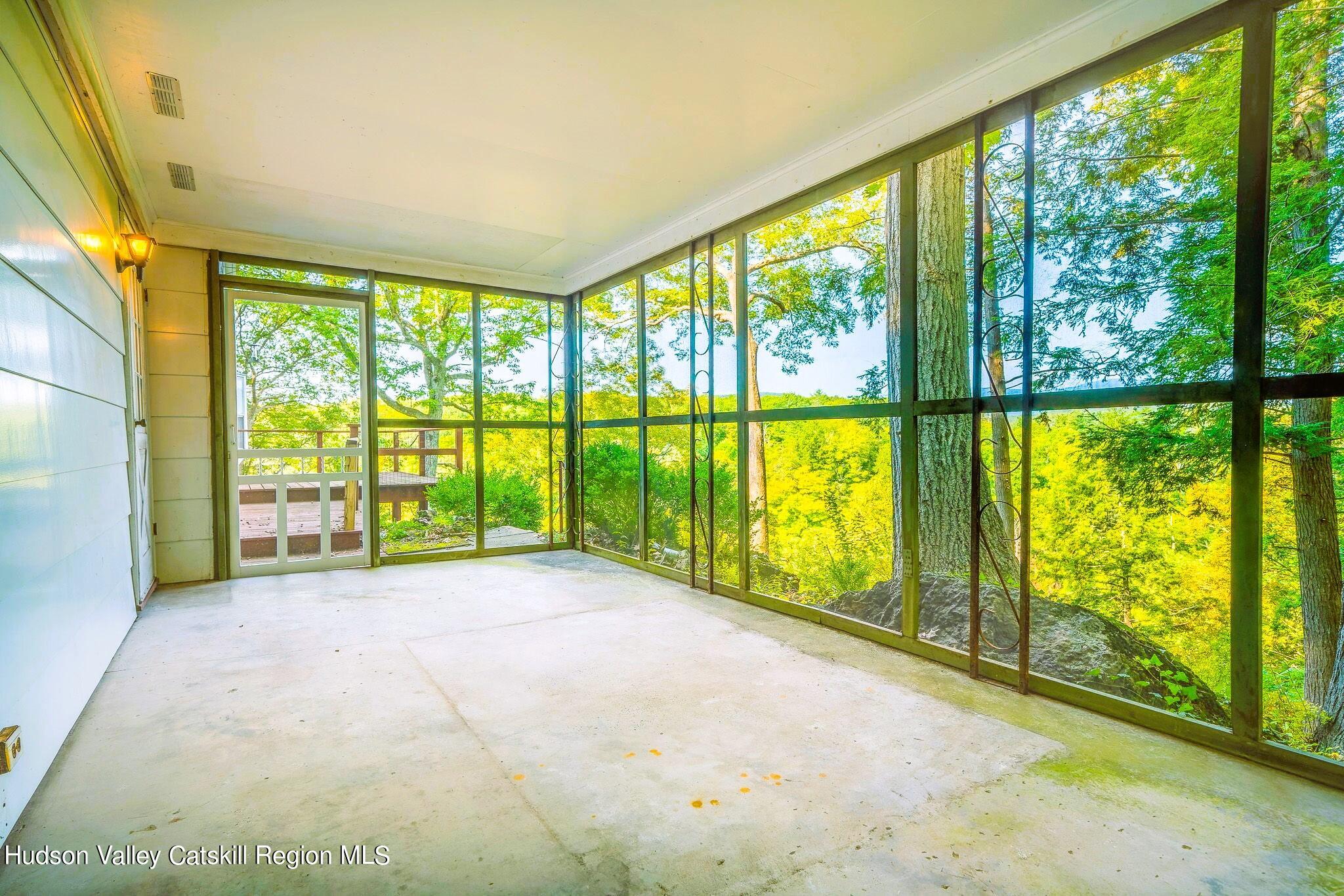 15 Dewitt Drive Saugerties, NY 12477 - Photo 4 of 5 a view of an empty room with large windows and a swimming pool
