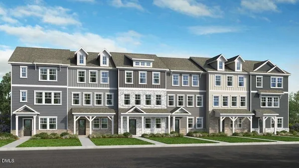 a front view of a residential apartment building with a yard