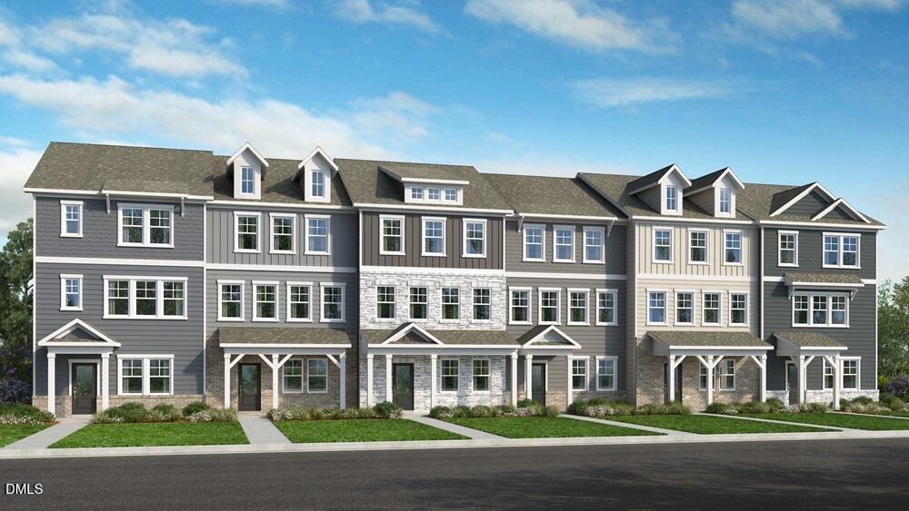 a front view of a residential apartment building with a yard