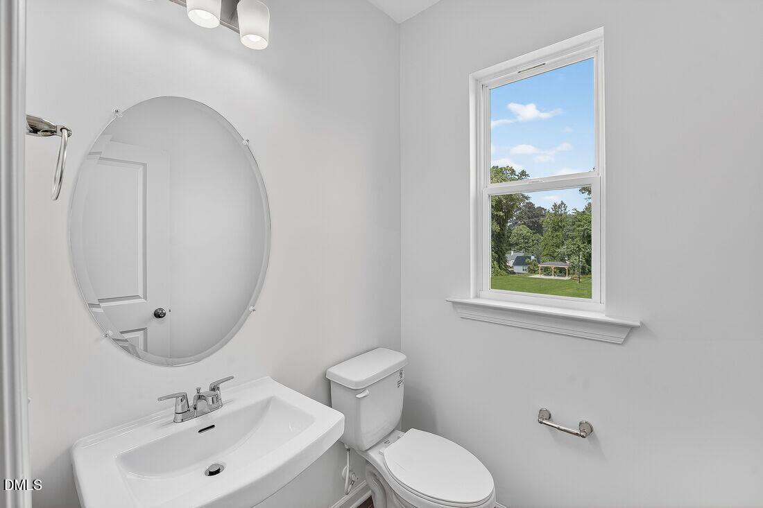 1324 West Garner Road, Unit 101 Garner, NC 27529 - Photo 19 of 29 a bathroom with a toilet sink and mirror