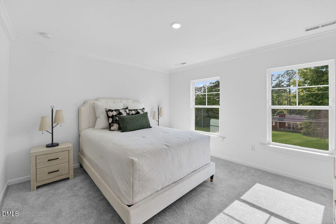 1324 West Garner Road, Unit 101 Garner, NC 27529 - Photo 20 of 29 a bedroom with a bed and a window