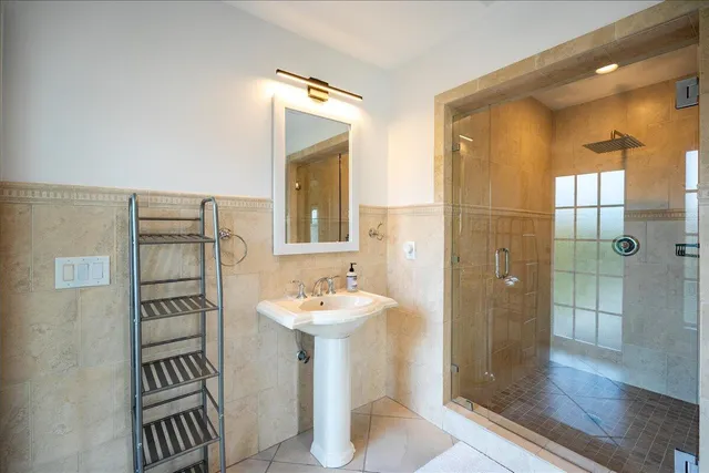 a bathroom with a sink a toilet and mirror