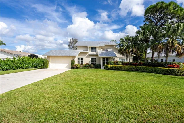 a front view of a house with a yard table and chairs