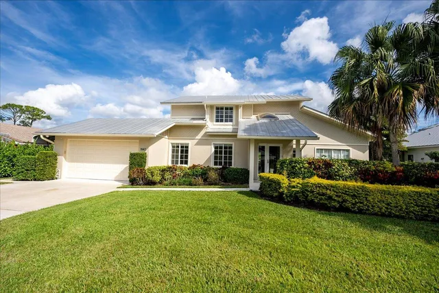a view of a dining room with furniture large windows and wooden floor
