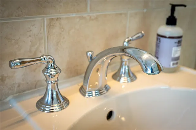 a bedroom with a bed and a large window with wooden floor