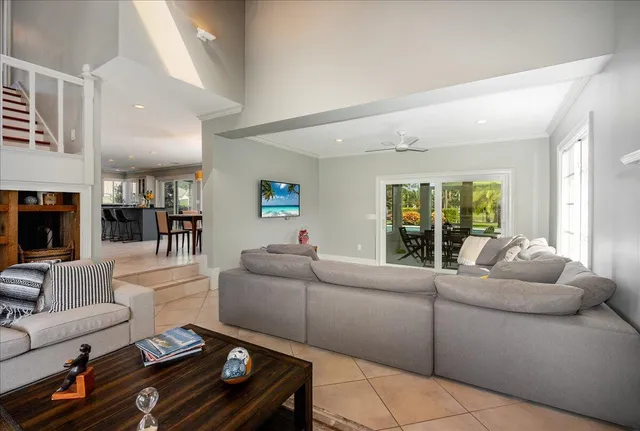a living room with furniture a fireplace and a floor to ceiling window